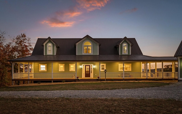 back house at dusk with a porch