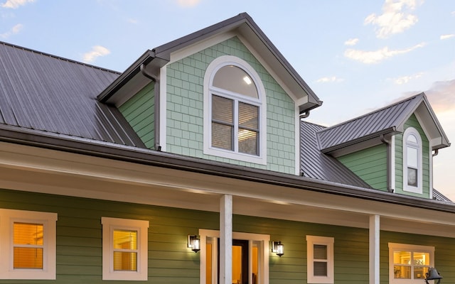 view of side of property with covered porch