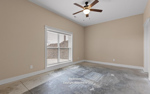 spare room with ceiling fan and concrete flooring