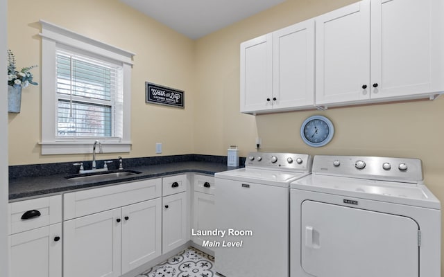 laundry area with cabinets, separate washer and dryer, sink, and light tile patterned floors