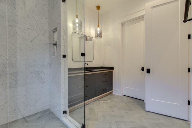 bathroom featuring parquet flooring and vanity