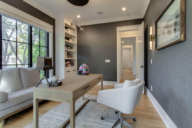 office area with ornamental molding and light wood-type flooring