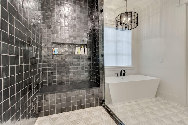 bathroom with a washtub and a chandelier