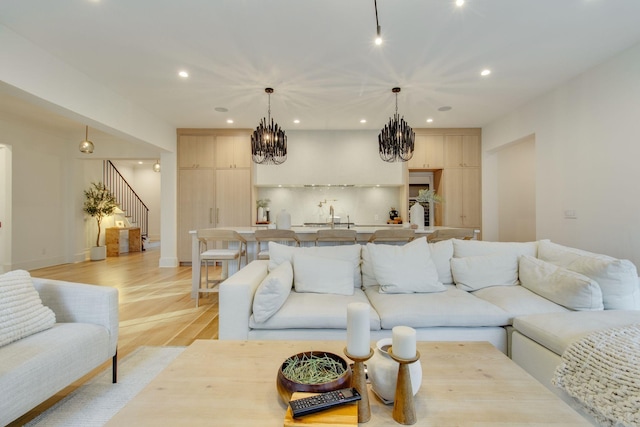 living room with sink and light hardwood / wood-style flooring