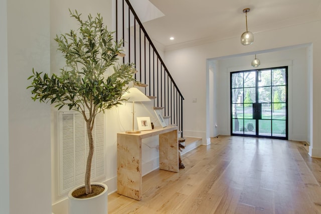 entryway featuring light hardwood / wood-style flooring and french doors