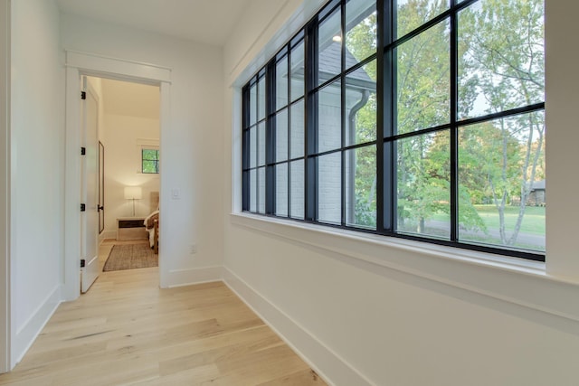 hall with light hardwood / wood-style floors