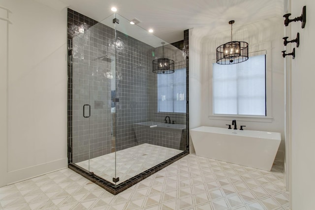 bathroom featuring shower with separate bathtub and a notable chandelier