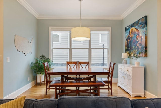 dining room featuring light hardwood / wood-style floors and ornamental molding