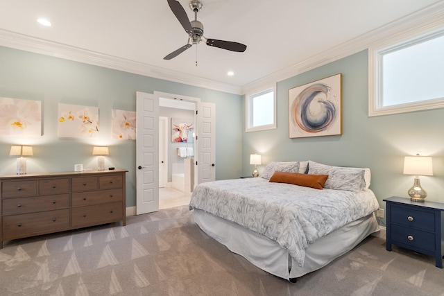 carpeted bedroom featuring ensuite bathroom, ceiling fan, and ornamental molding