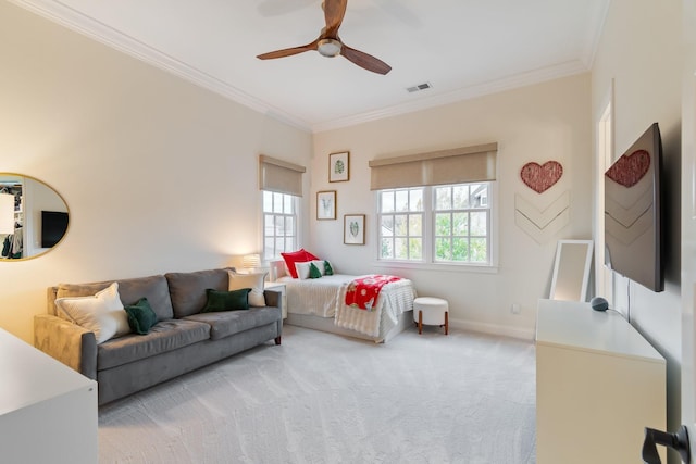 bedroom with ceiling fan, crown molding, and light colored carpet