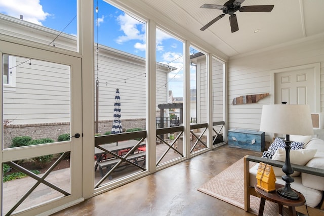 sunroom featuring ceiling fan