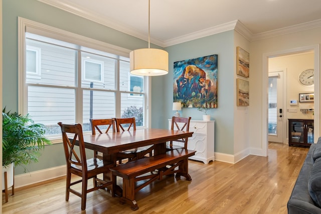 dining room featuring light hardwood / wood-style floors and ornamental molding