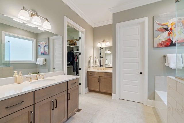 bathroom with tile patterned flooring, vanity, a relaxing tiled tub, and ornamental molding