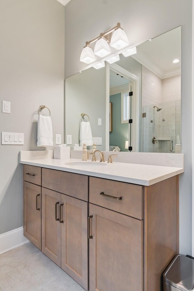 bathroom featuring crown molding, vanity, and an enclosed shower