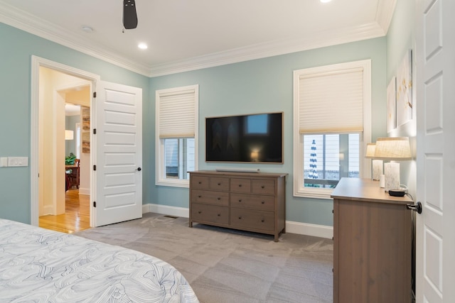 bedroom featuring ceiling fan, light colored carpet, and ornamental molding