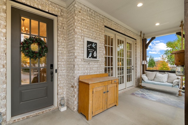 view of exterior entry featuring covered porch