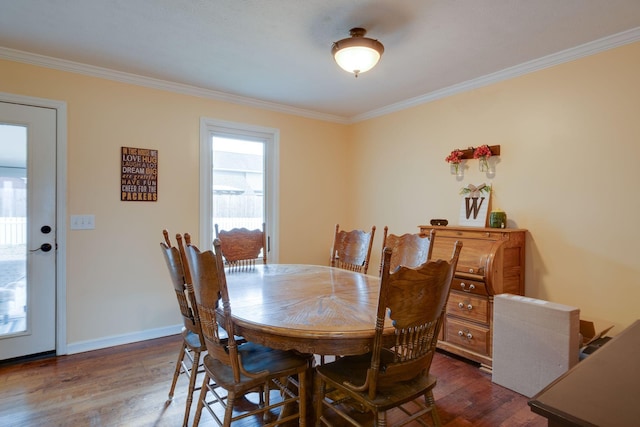 dining room featuring dark hardwood / wood-style floors and crown molding