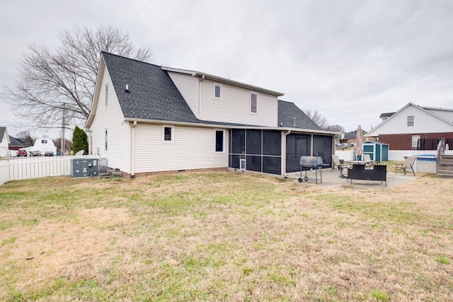 rear view of property featuring a sunroom, a yard, and a patio