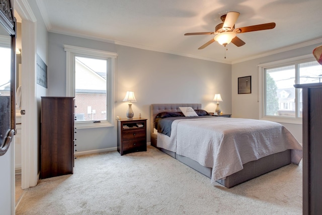 bedroom featuring ceiling fan, light colored carpet, and crown molding