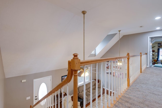 corridor with carpet flooring and lofted ceiling with skylight