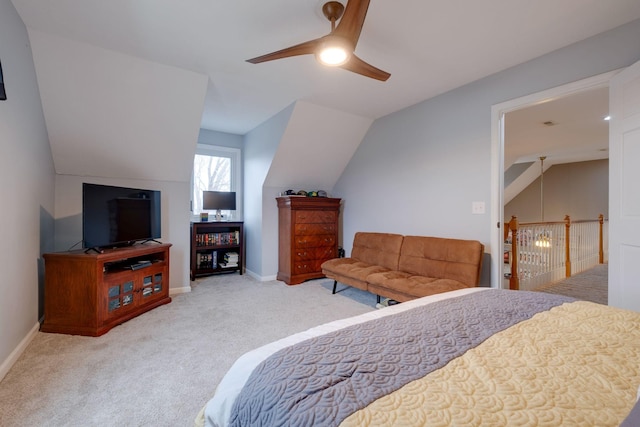 carpeted bedroom with vaulted ceiling and ceiling fan