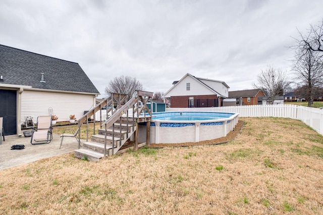 view of swimming pool with a patio area and a lawn