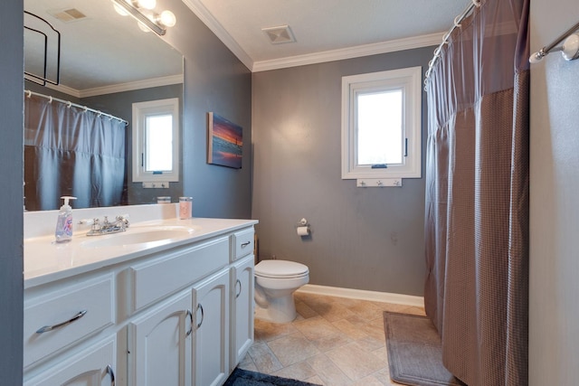 bathroom with vanity, a healthy amount of sunlight, toilet, and crown molding