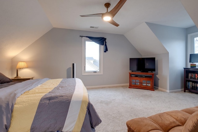 carpeted bedroom featuring multiple windows, ceiling fan, and lofted ceiling