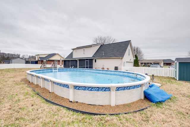 view of pool featuring a sunroom and a lawn