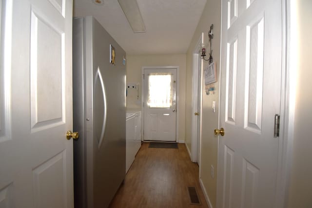 doorway featuring wood-type flooring and independent washer and dryer