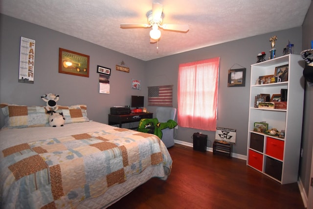 bedroom with ceiling fan, dark hardwood / wood-style flooring, and a textured ceiling