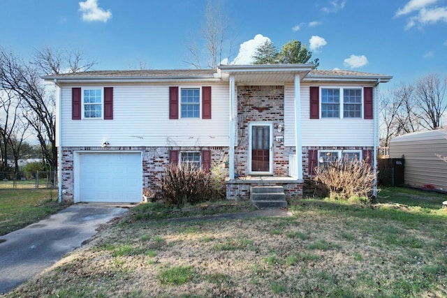 split foyer home with a front lawn and a garage