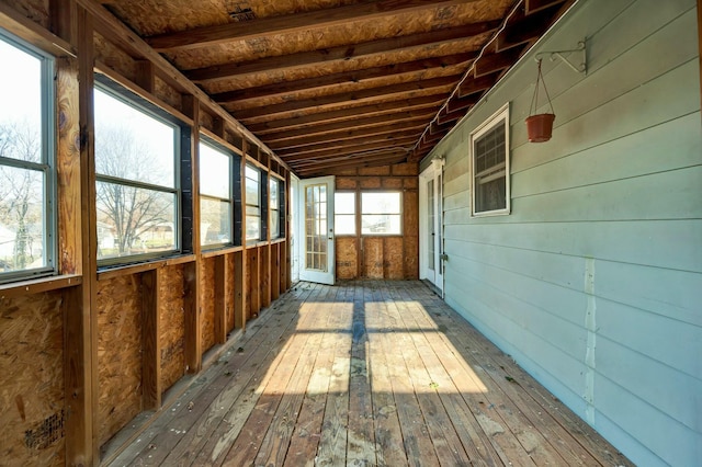 unfurnished sunroom featuring vaulted ceiling