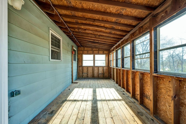 unfurnished sunroom featuring vaulted ceiling