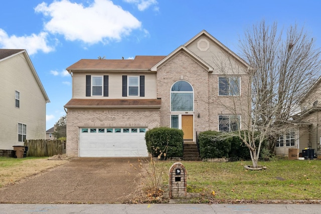 view of property with a garage and a front lawn