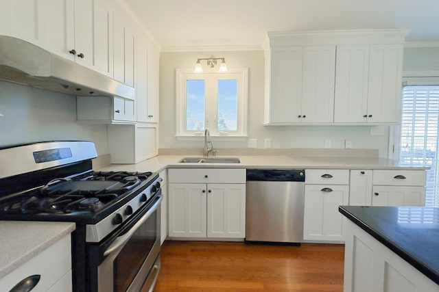 kitchen featuring stainless steel appliances, sink, white cabinets, and dark hardwood / wood-style floors