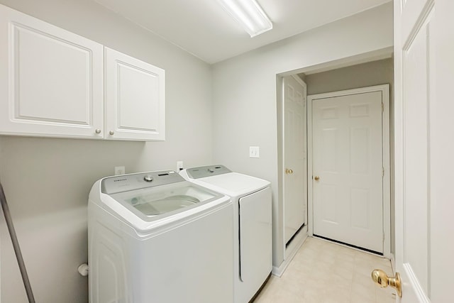 laundry room featuring cabinets and washing machine and clothes dryer