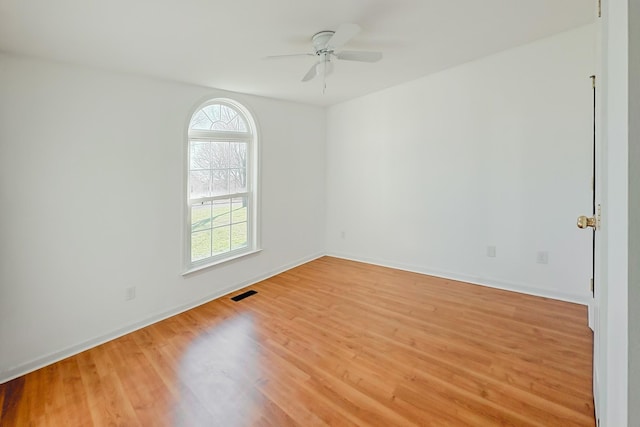 unfurnished room with ceiling fan and hardwood / wood-style floors