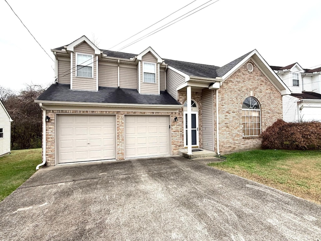 view of front of house featuring a garage and a front lawn