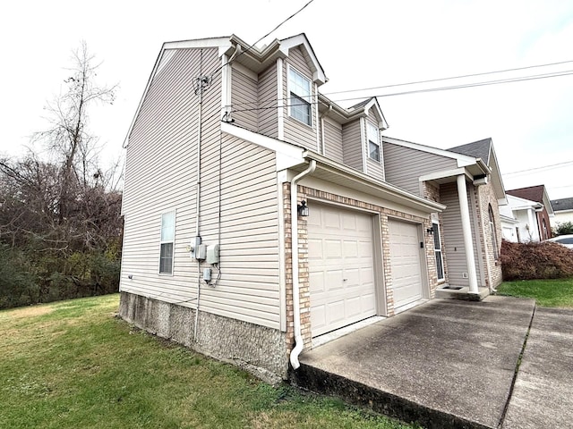 view of side of home featuring a yard and a garage