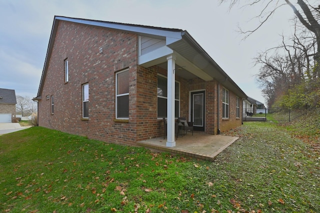 view of home's exterior featuring a patio area and a yard