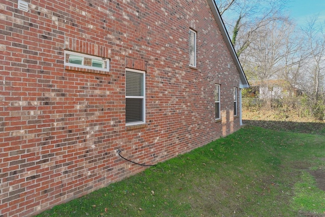 view of side of home with a lawn