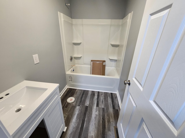 bathroom featuring hardwood / wood-style floors, vanity, and shower / washtub combination