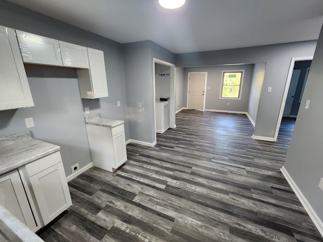 kitchen featuring white cabinetry and dark wood-type flooring