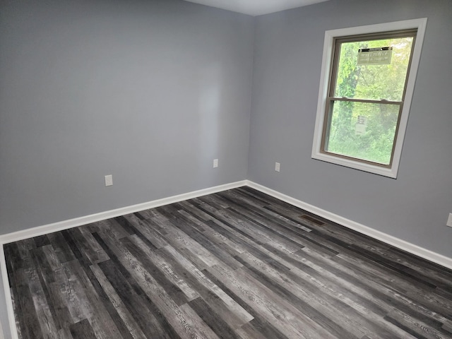 spare room featuring dark hardwood / wood-style flooring