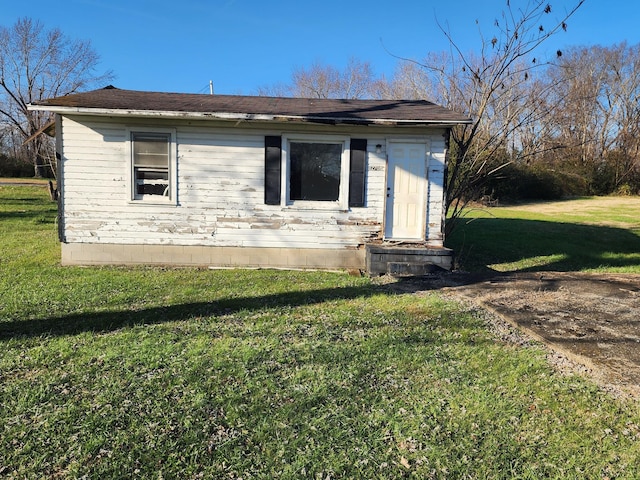 view of side of home with a yard