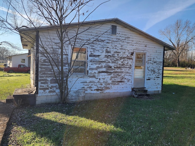 view of property exterior with a yard