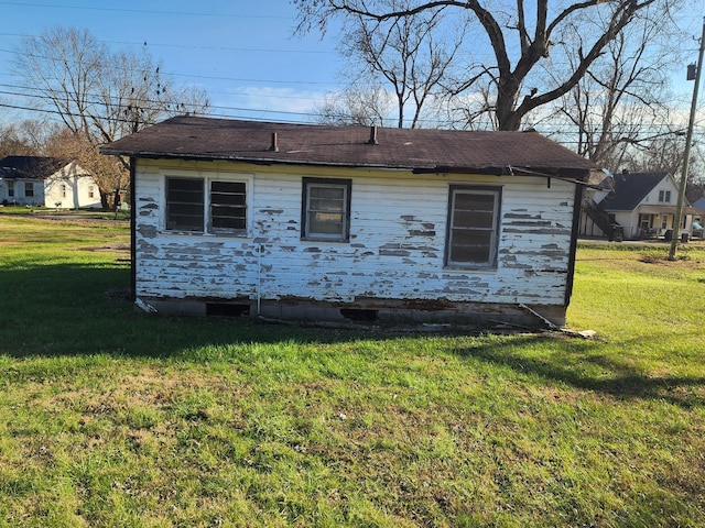 view of side of home featuring a yard