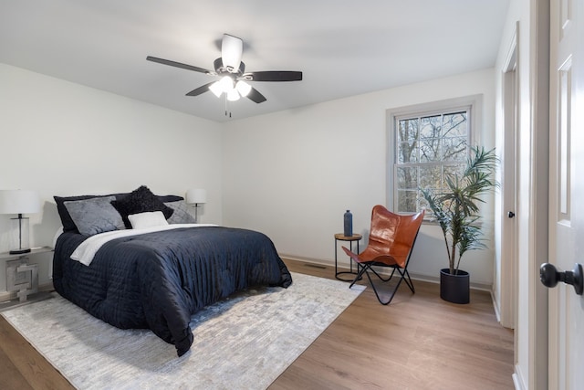 bedroom with hardwood / wood-style flooring and ceiling fan