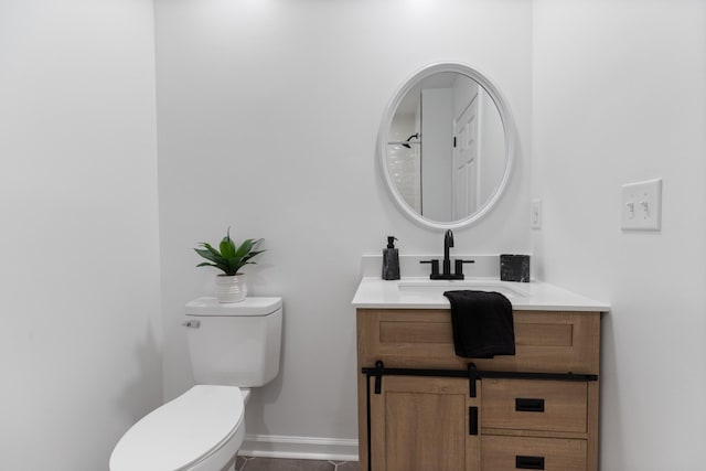 bathroom featuring tile patterned floors, vanity, and toilet